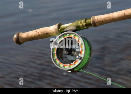 Salmon spey fly rod and reel resting on gravel and snow in British