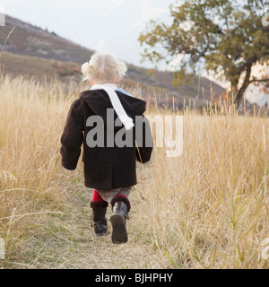 Girl walking in a meadow Stock Photo