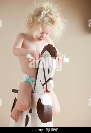 Toddler on rocking horse Stock Photo