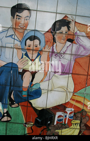 A tiled mural in a Guangzhou street advocates 'happy families', and China's 'one child' policy for families, China. Stock Photo