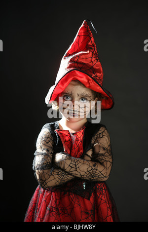 Toddler beautiful witch girl wearing halloween costume and make up Stock Photo