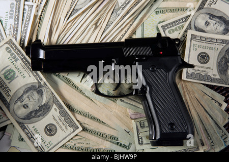 Dollar notes and gun, black pistol, mafia inspiration Stock Photo