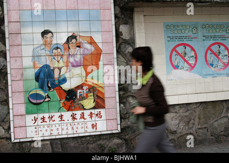 A tiled mural in a Guangzhou street advocates 'happy families', and China's 'one child' policy for families, China. Stock Photo