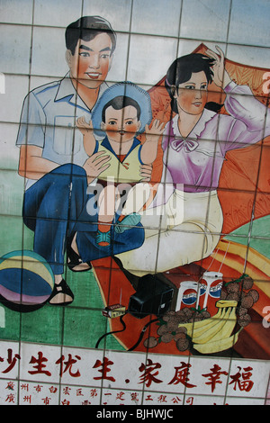 A tiled mural in a Guangzhou street advocates 'happy families', and China's 'one child' policy for families, China. Stock Photo