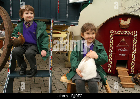 girl holding rabbit in Gypsy Caravan Stock Photo