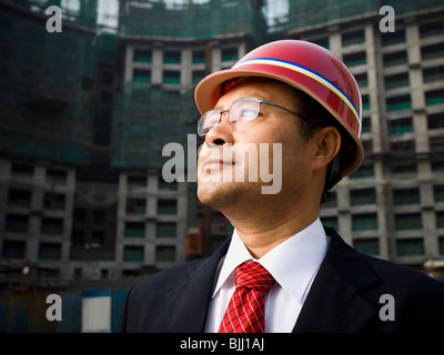Businessman with construction helmet outdoors