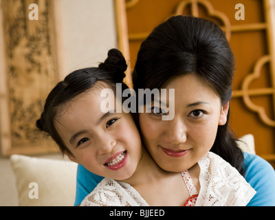 Mother giving daughter a kiss on cheek Stock Photo