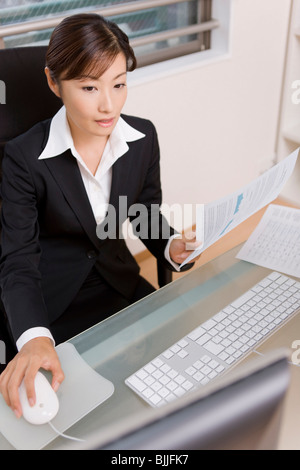 Young businesswoman working at desk Stock Photo