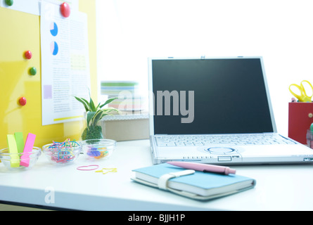 Laptop and notebook on desk Stock Photo
