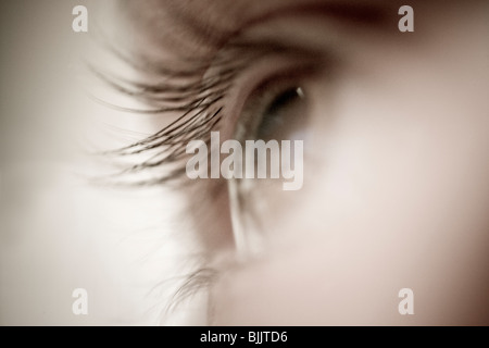 Close-up of woman's eye and eyelashes looking off in distance, soft and fuzzy, monochromatic Stock Photo