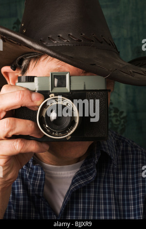 A photographer using an old (1964) toy camera. Stock Photo