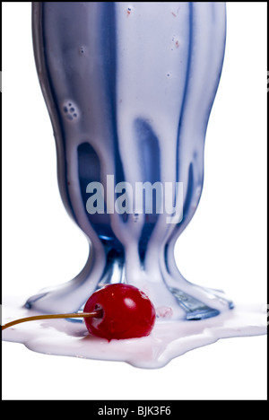 Melting milkshake with two straws and maraschino cherry Stock Photo
