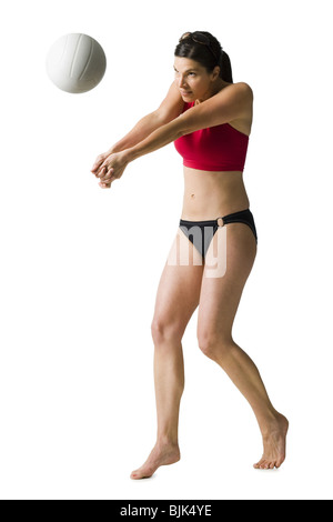 Woman in bikini playing volleyball Stock Photo