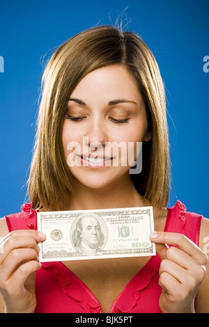 Woman holding American hundred dollar bill Stock Photo