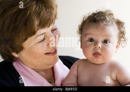 Grandmother holding baby smiling Stock Photo