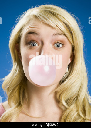 Girl blowing bubble and cross eyed Stock Photo