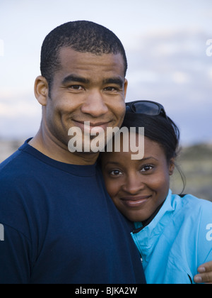 Man and woman hugging outdoors Stock Photo