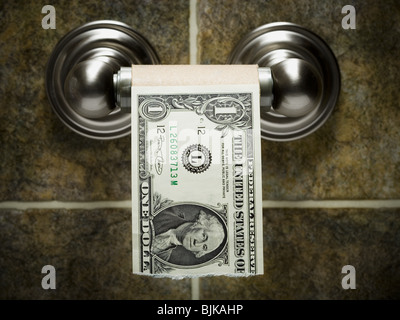 US dollar bills on toilet paper roll Stock Photo