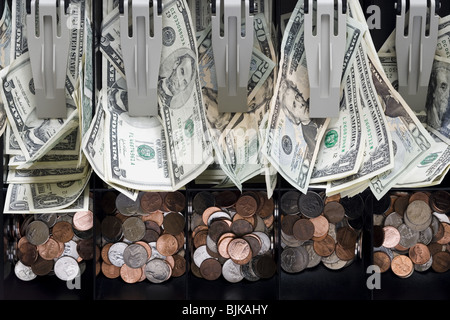 Detailed view of messy US currency and coins in till Stock Photo