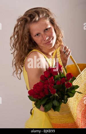 Woman with a bouquet of roses in a bag Stock Photo
