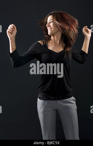 Woman in black dancing Stock Photo