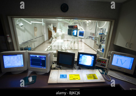 Male x-ray technician sitting at computers Stock Photo