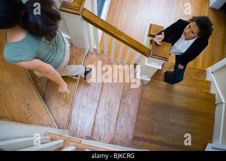 Two women arguing on staircase Stock Photo