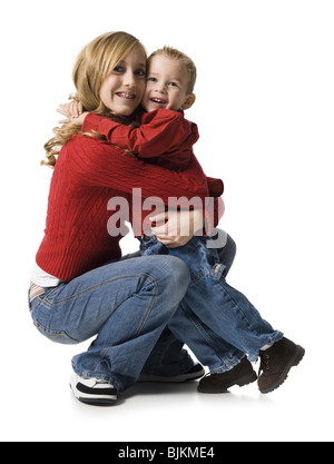 Teenage girl hugging young boy Stock Photo