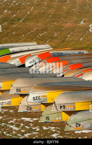 Piles of boats along the Quabbin Reservoir, in winter, waiting for spring to come. Stock Photo