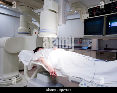 Woman undergoing x-ray in lab Stock Photo