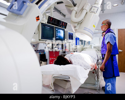 Woman undergoing x-ray in lab Stock Photo