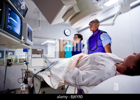 Woman undergoing x-ray in lab Stock Photo