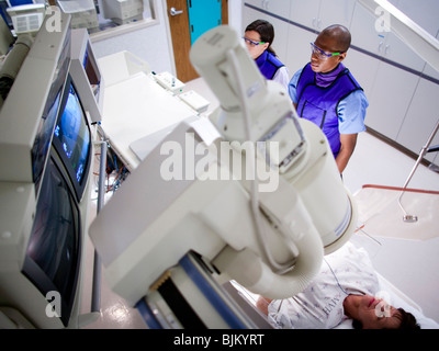 Woman undergoing x-ray in lab Stock Photo