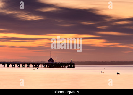 Sun setting over Yarmouth Pier. Isle of Wight, England, UK Stock Photo