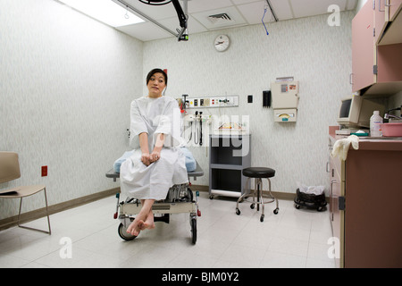 Female patient waiting anxiously in examining room Stock Photo