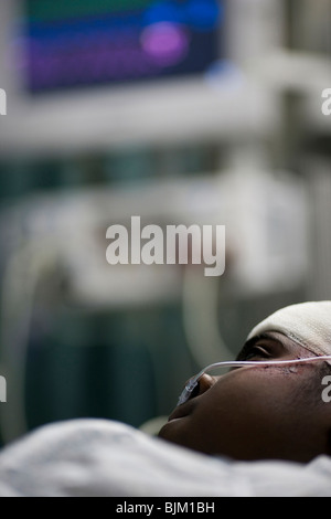 Boy in hospital bed with head bandages Stock Photo