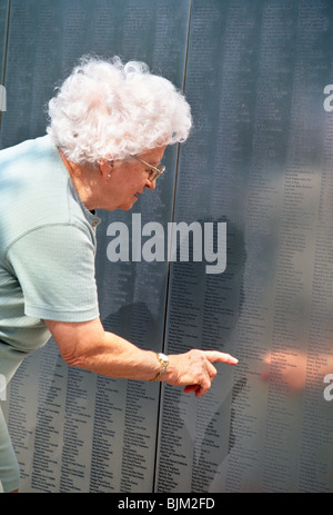 Senior Woman at the Immigrant Wall of Honor, Ellis Island, NYC Stock Photo