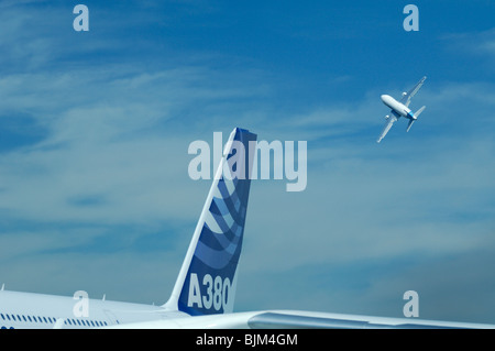 Airliners Airbus A380 tail fin and an Airbus A300 taking off during 48th Paris International Air show 2009. Le Bourget airport Stock Photo