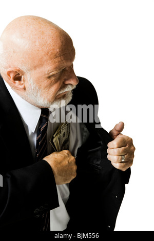 Mature businessman pocketing cash Stock Photo