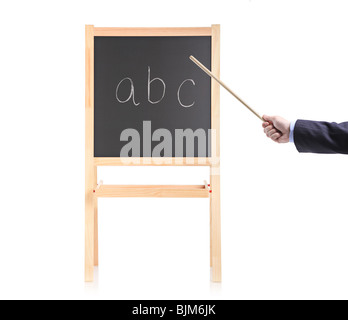 Hand holding a pointing stick on a black school board Stock Photo
