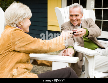 Mature couple toasting outdoors Stock Photo