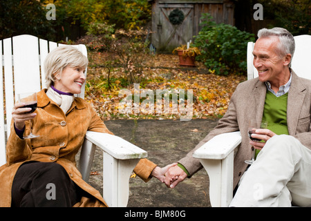 Mature couple toasting outdoors Stock Photo