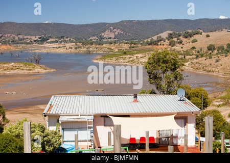 Houses built as lake frontage on Lake Eildon are left high and dry by the ongoing drought, Australia. Stock Photo