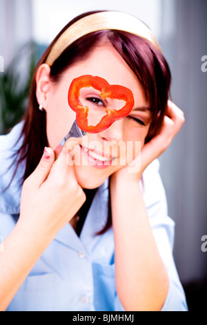Young woman with red bell pepper Stock Photo