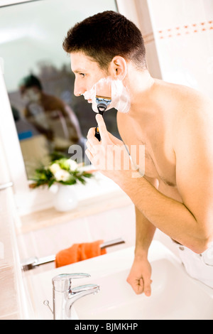Young man shaving Stock Photo