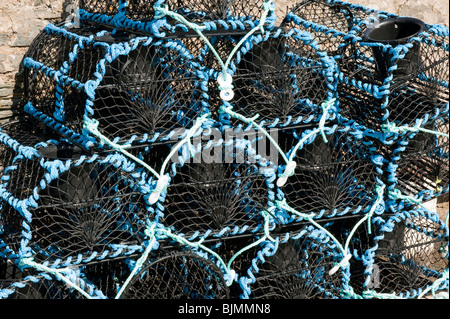 Lobster pots lined up on quayside Stock Photo