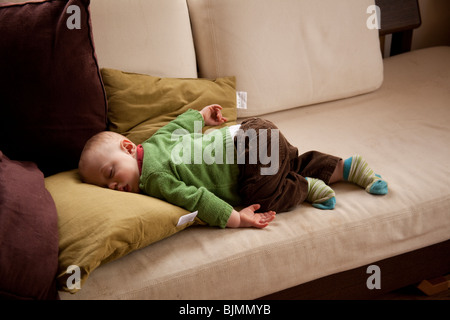 Baby boy (eleven months old )sleeping on a sofa Hampshire England. Stock Photo