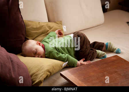 Baby boy (eleven months old )sleeping on a sofa Hampshire England. Stock Photo