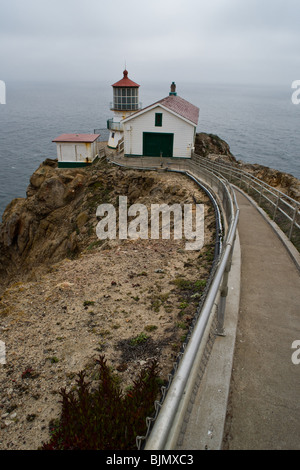 A long flight of stairs leads down the cliff to the lighthouse at Point Reyes National Seashore. Stock Photo