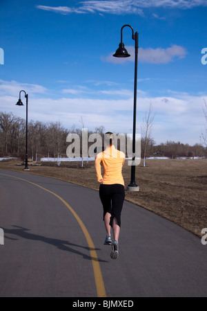 Young woman running outdoors in the city Stock Photo